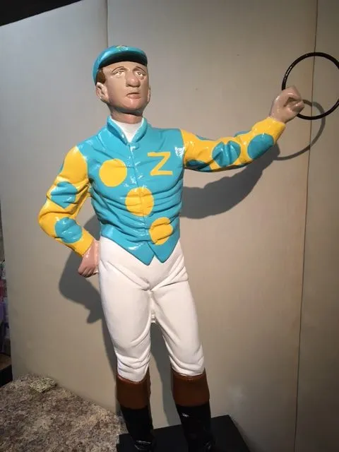 A lawn jockey statue hand painted by Saratoga Signature Interior